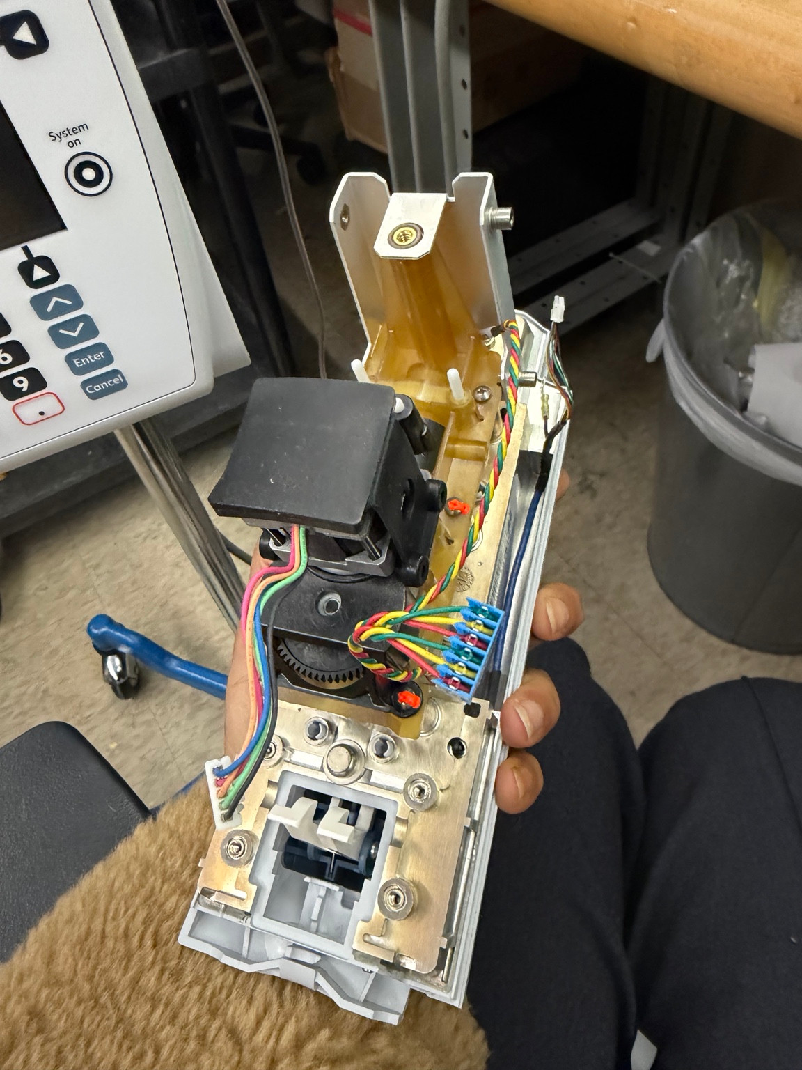 Alaris 8100 pump mechanism, motor and wiring exposed during service.