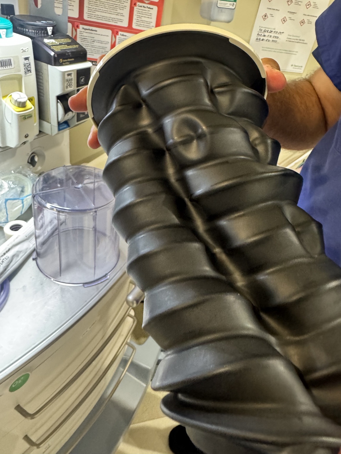Anesthesia ventilator bellows held outside the transparent housing during service work