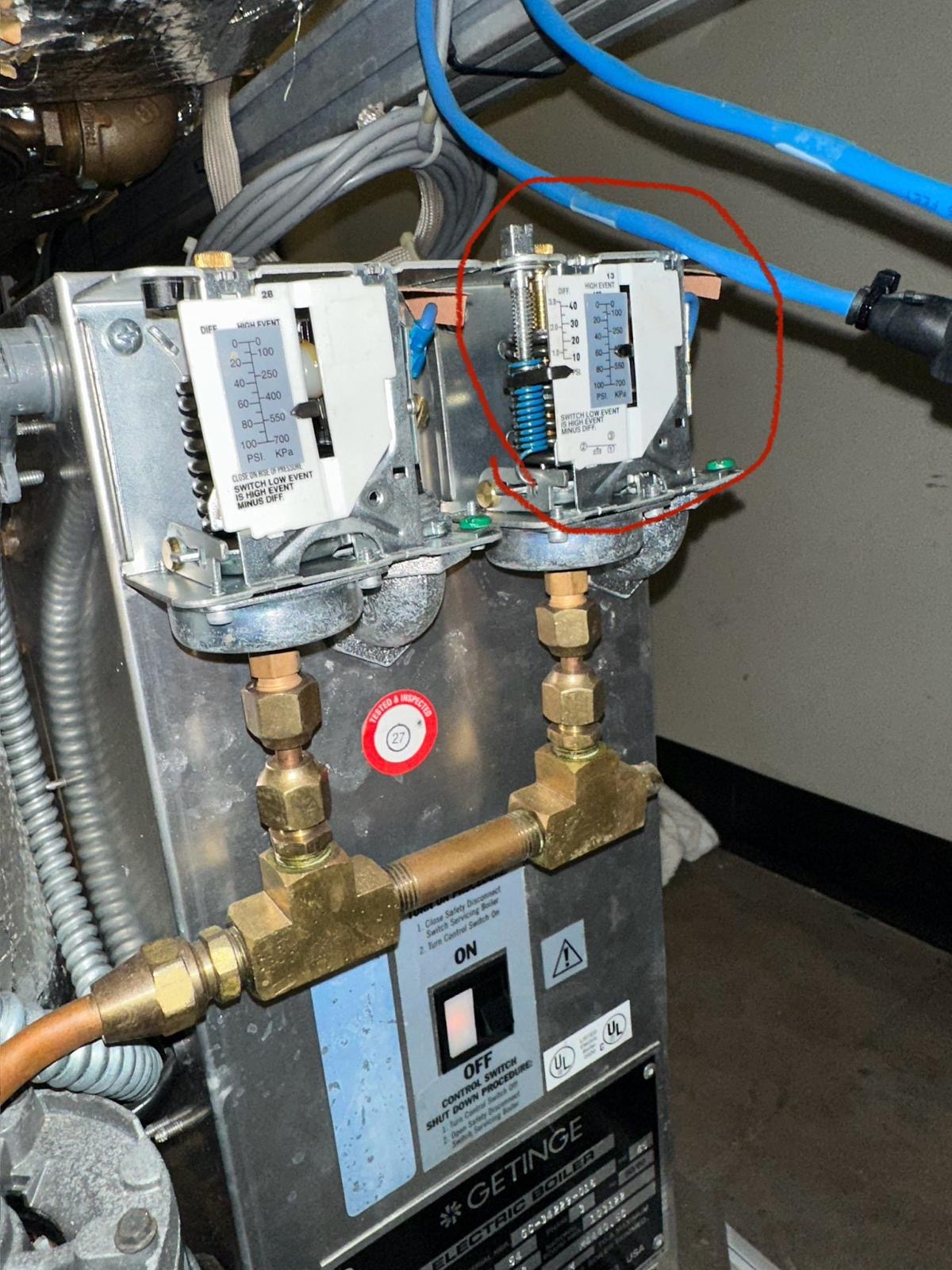 Getinge electric boiler pressure controls with the replaced pressure switch marked by a red circle.