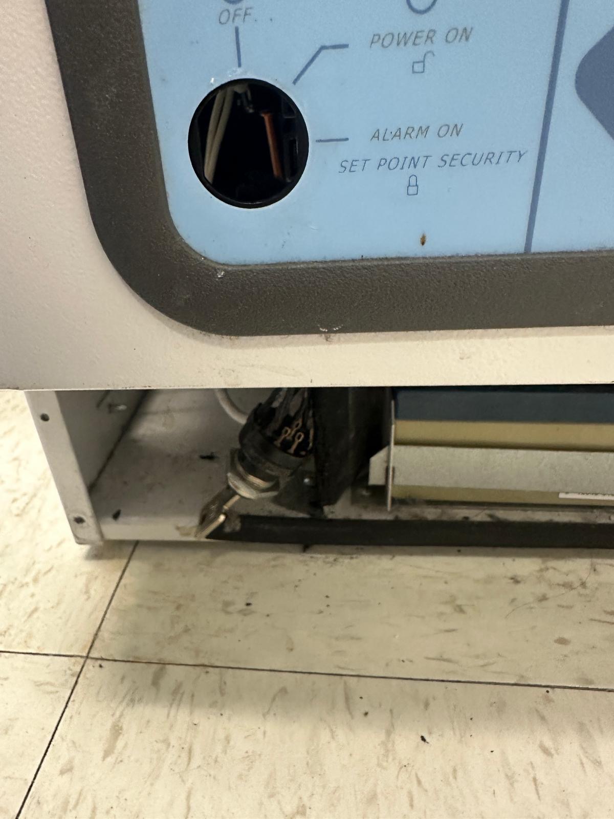 Laboratory freezer control panel with the displaced switch visible during service