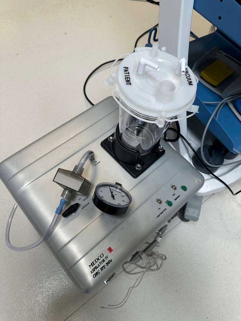 MEDCO Aspirator IV suction unit with collection canister, vacuum gauge and tubing during preventive maintenance.