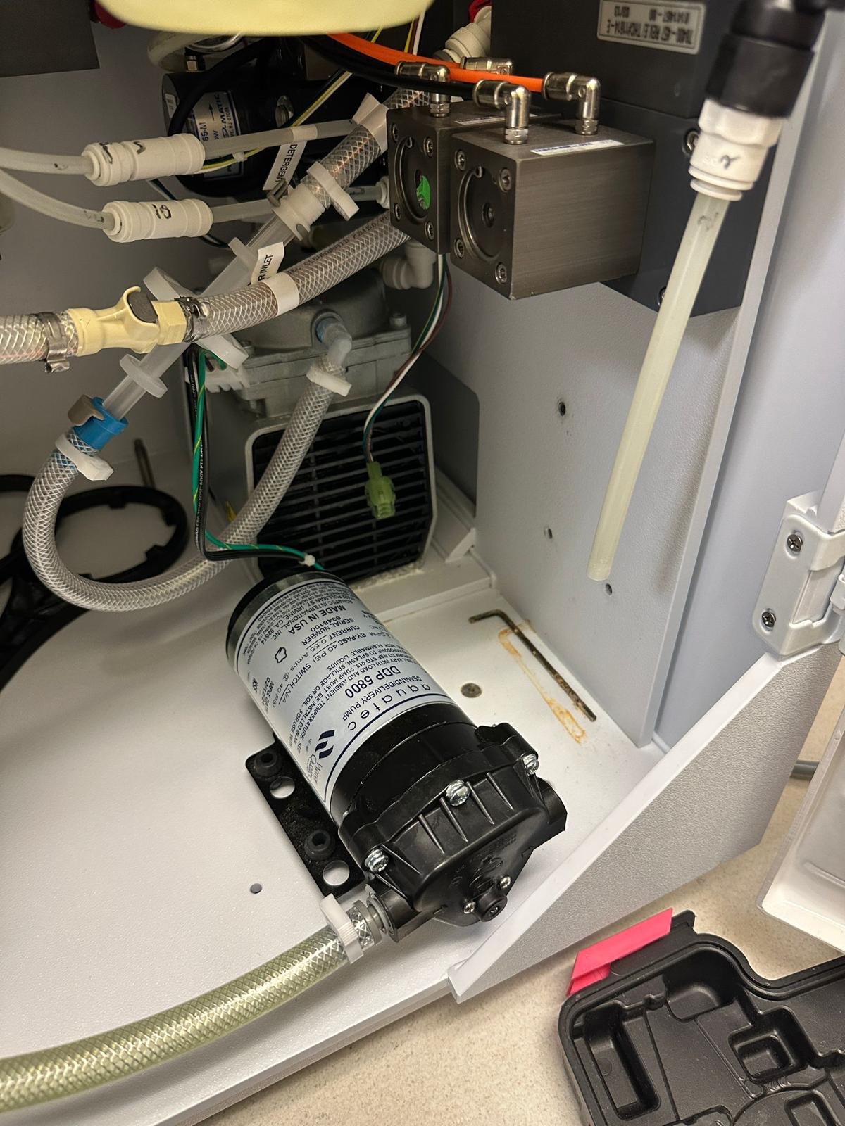 Internal tubing, valves and pump visible inside the Medivators endoscope reprocessor during service.