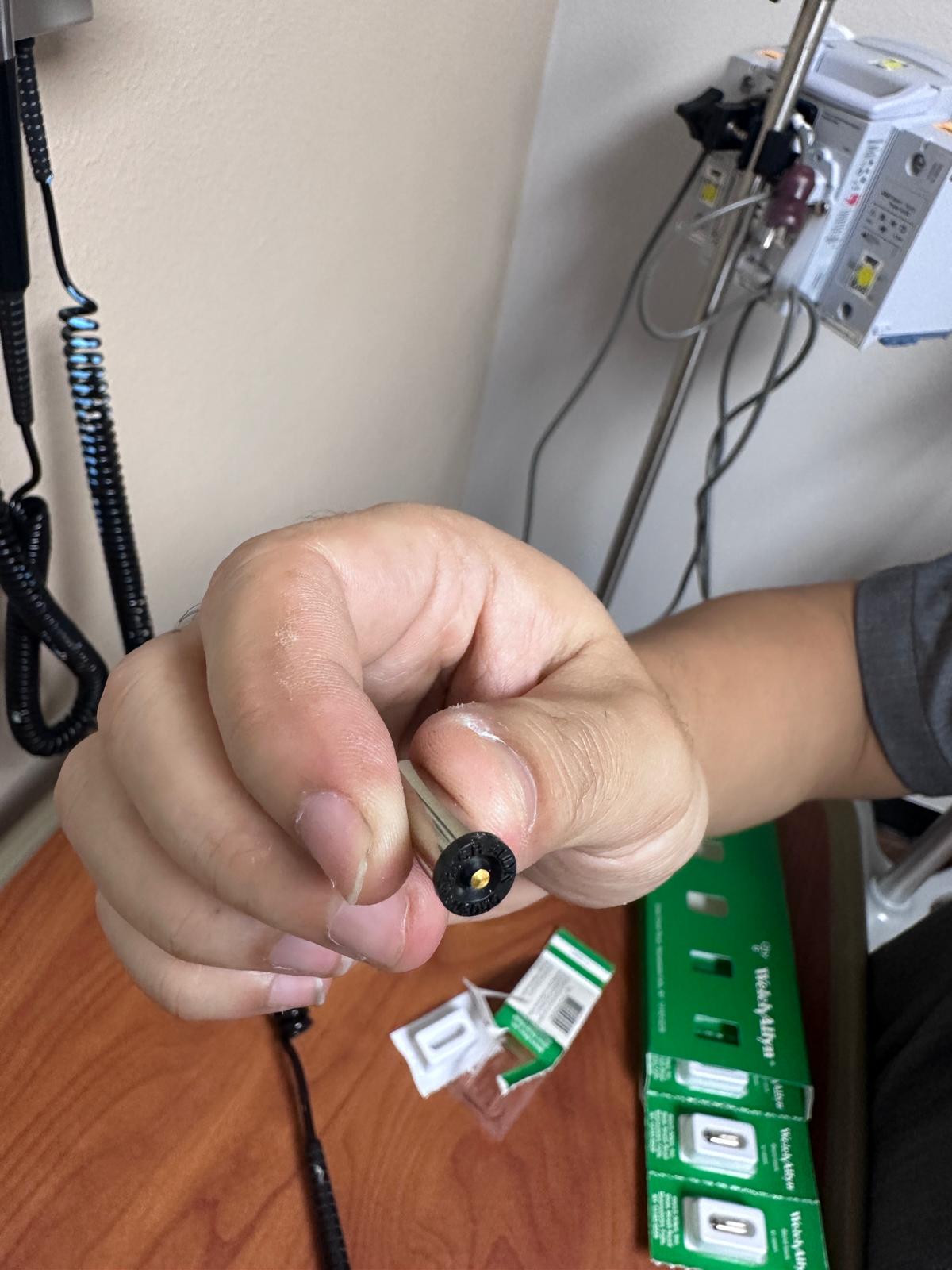 Otoscope lamp shown during equipment service.